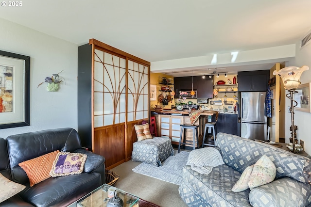 living room with carpet and rail lighting