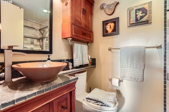 full bathroom featuring vanity, toilet, and walk in shower