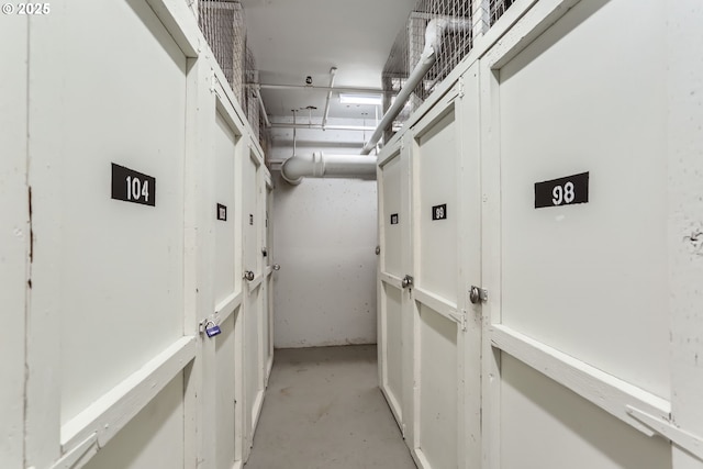 corridor with unfinished concrete flooring