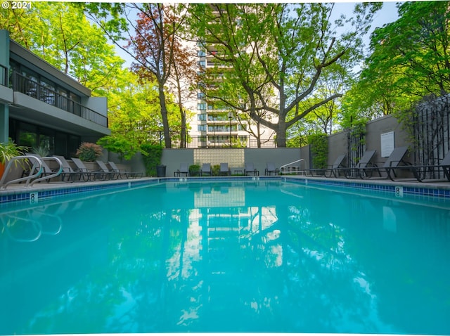 community pool featuring fence