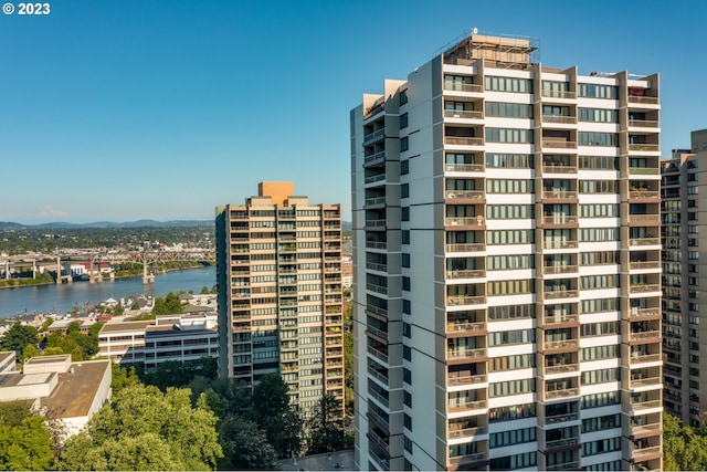 exterior space with a water view and a city view