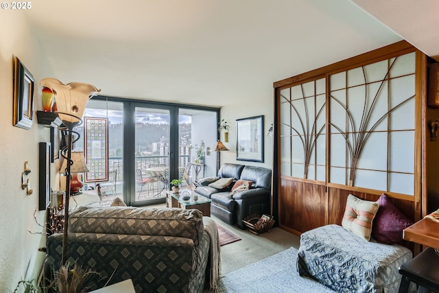 living area with carpet floors and floor to ceiling windows