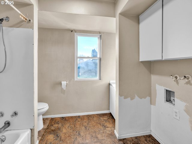 bathroom with shower / bath combination and toilet