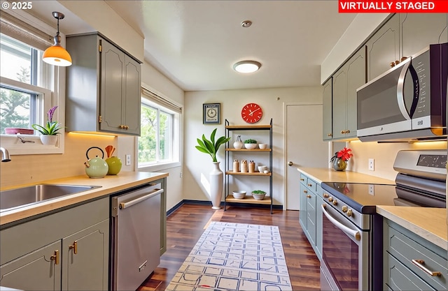 6312 SW Lesser Way, Portland, OR 97219 - kitchen with appliances with stainless steel finishes, a sink, gray cabinetry, and dark wood-type flooring