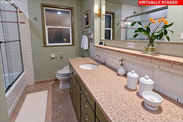6312 SW Lesser Way, Portland, OR 97219 - bathroom featuring backsplash, toilet, tile patterned floors, vanity, and bath / shower combo with glass door