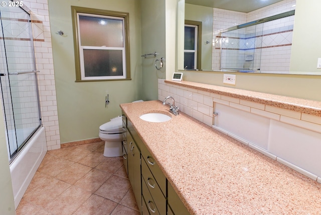 6312 SW Lesser Way, Portland, OR 97219 - bathroom featuring toilet, bath / shower combo with glass door, vanity, tile patterned floors, and baseboards