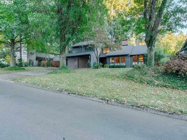 view of front of property featuring a garage and a front lawn