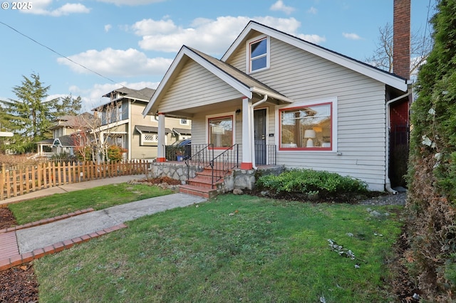 view of front facade featuring covered porch and a front lawn