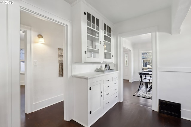 interior space with white cabinetry and dark hardwood / wood-style floors