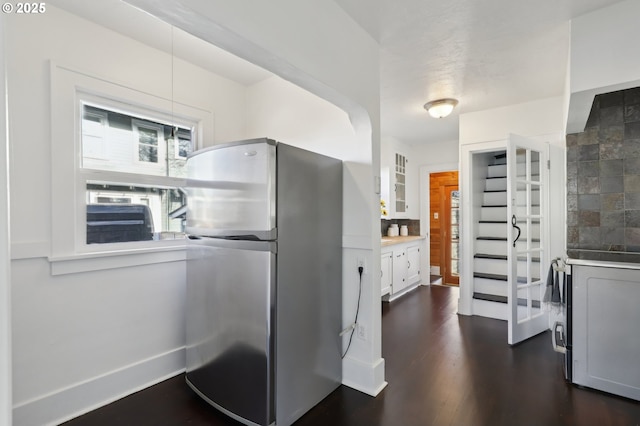 kitchen featuring white cabinetry, stainless steel fridge, and dark wood-type flooring