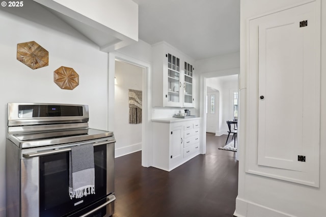 kitchen featuring white cabinets, stainless steel range with electric cooktop, and dark wood-type flooring