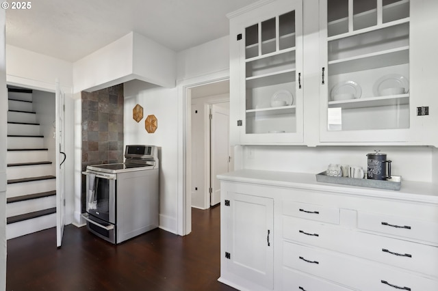 kitchen with electric range, dark hardwood / wood-style floors, and white cabinetry