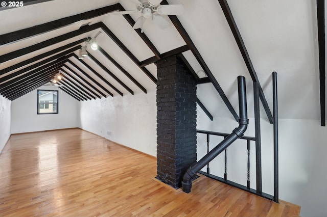 bonus room featuring vaulted ceiling with beams, light hardwood / wood-style floors, and ceiling fan