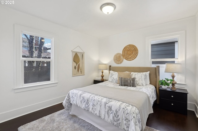 bedroom with dark hardwood / wood-style flooring