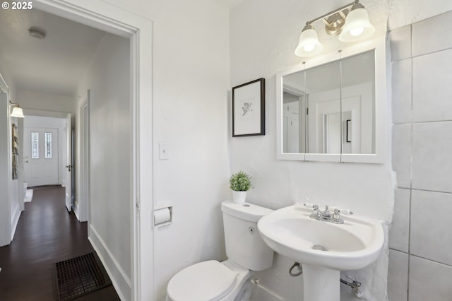 bathroom with hardwood / wood-style floors, toilet, and sink