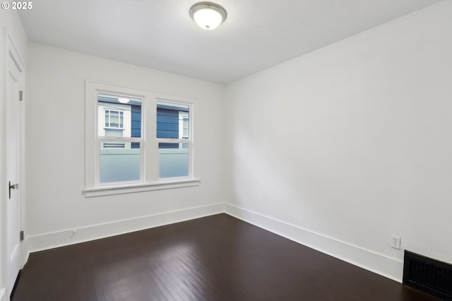 empty room with dark hardwood / wood-style floors