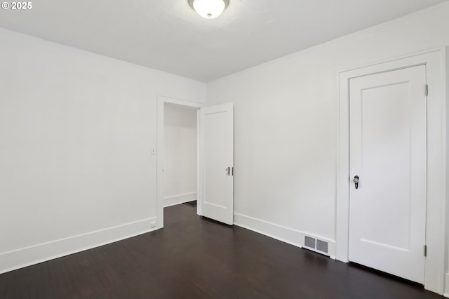 unfurnished bedroom featuring dark hardwood / wood-style flooring