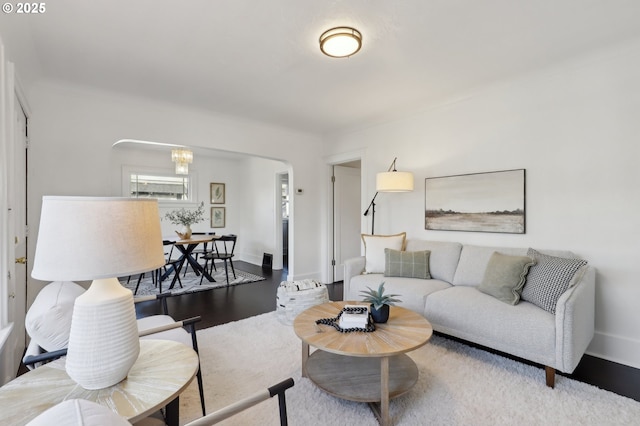 living room featuring a chandelier and wood-type flooring