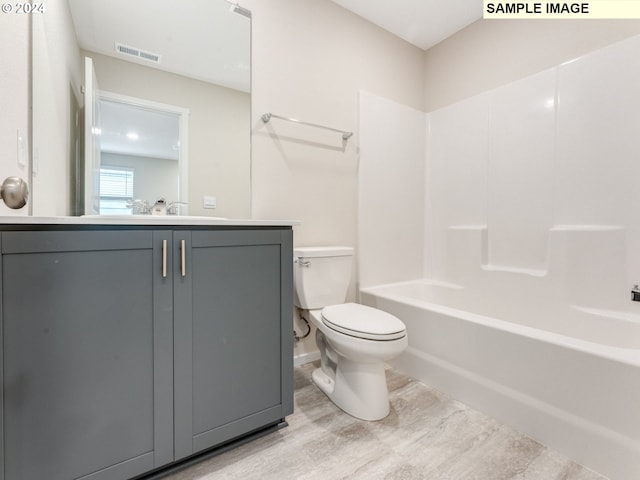 full bathroom featuring vanity, tub / shower combination, and toilet