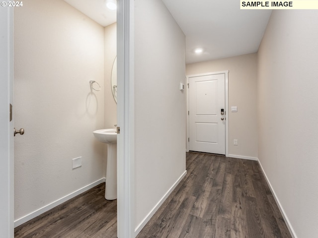 hallway featuring dark hardwood / wood-style floors and sink