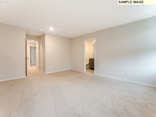 unfurnished room with light colored carpet