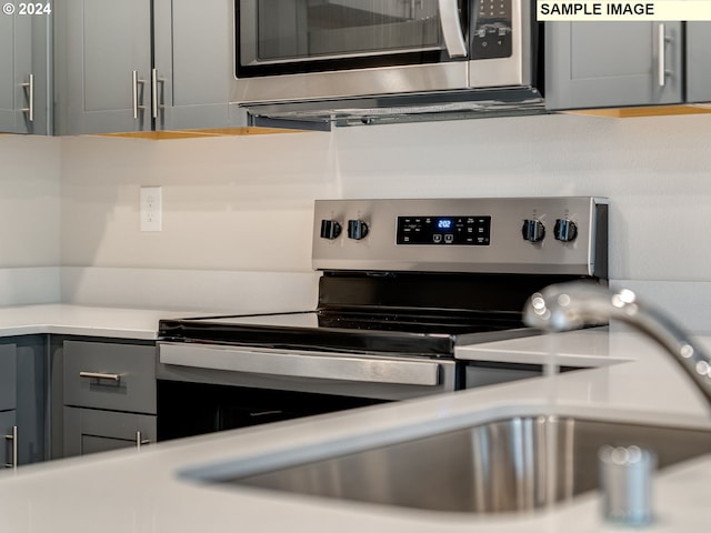 kitchen featuring gray cabinets and stainless steel appliances