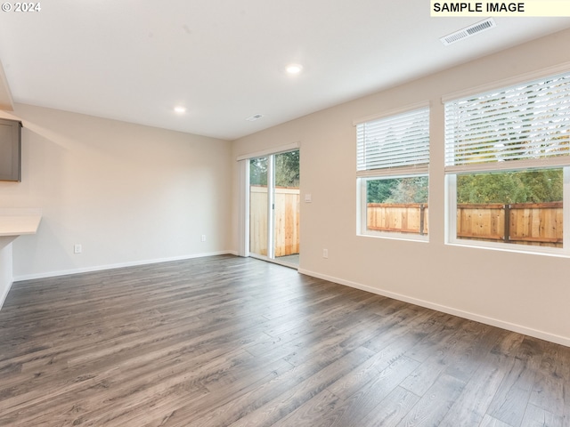 empty room featuring dark hardwood / wood-style flooring