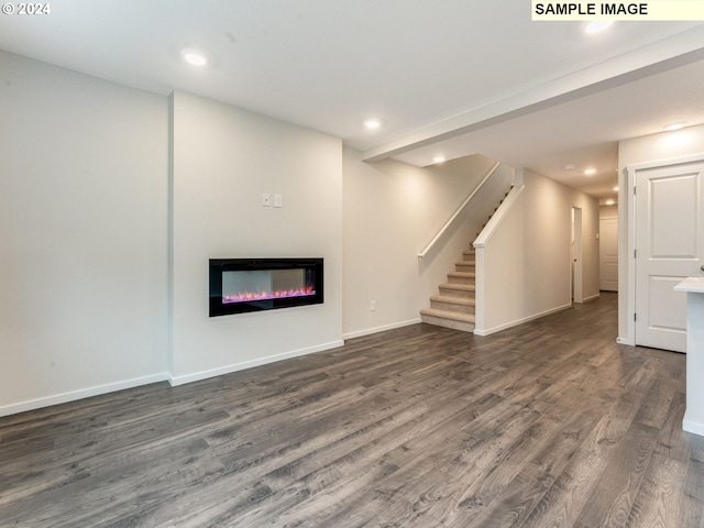 unfurnished living room featuring dark wood-type flooring