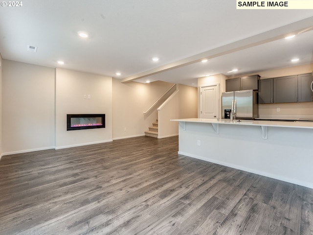 unfurnished living room featuring dark hardwood / wood-style flooring