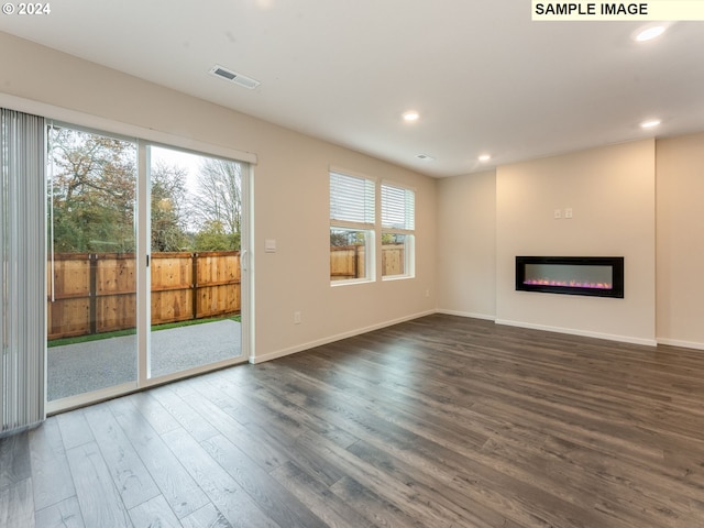 unfurnished living room with dark hardwood / wood-style floors