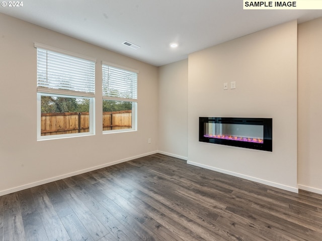 unfurnished living room featuring dark wood-type flooring