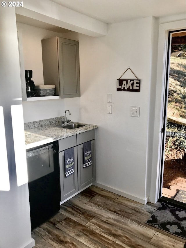 kitchen featuring gray cabinets, sink, dark hardwood / wood-style flooring, and black dishwasher