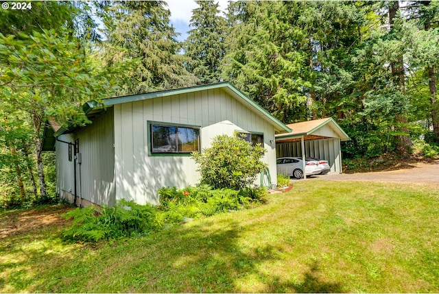 view of side of property with a yard and a carport