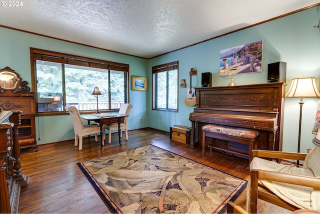 sitting room with a textured ceiling, dark hardwood / wood-style flooring, and ornamental molding