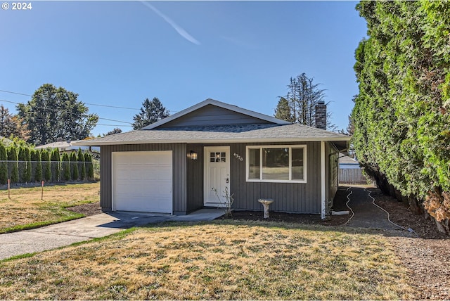 view of front of house with a front yard and a garage