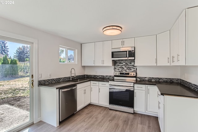 kitchen featuring light hardwood / wood-style floors, stainless steel appliances, sink, and white cabinets