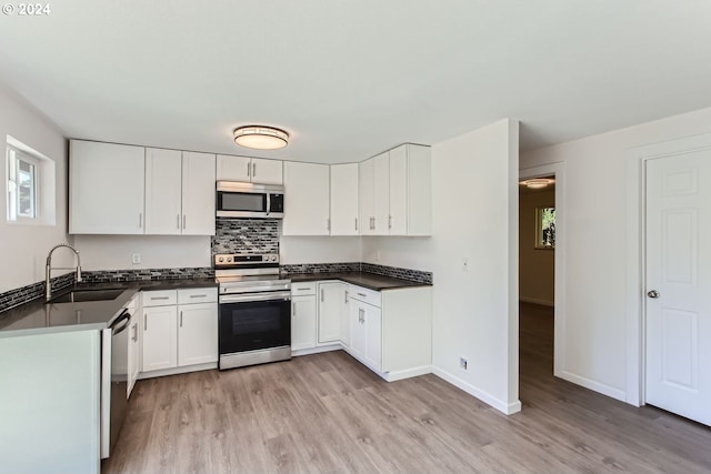 kitchen featuring light hardwood / wood-style floors, white cabinetry, stainless steel appliances, and sink