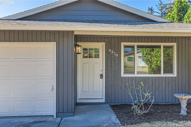 view of exterior entry featuring a garage