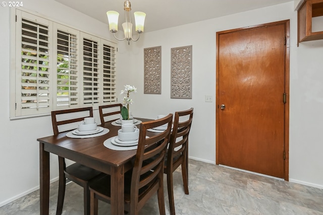 dining area featuring a notable chandelier