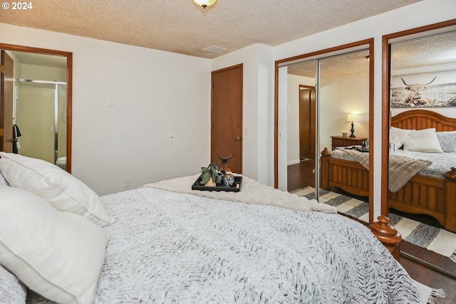 bedroom with a textured ceiling and hardwood / wood-style floors