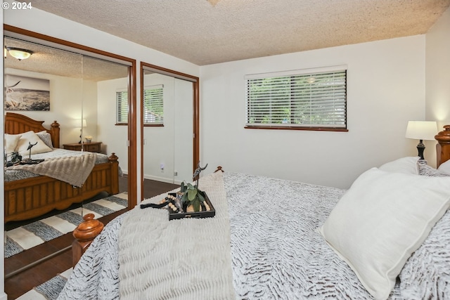 bedroom featuring multiple windows and a textured ceiling