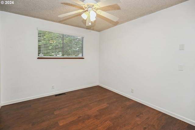 empty room featuring a textured ceiling, ceiling fan, and dark hardwood / wood-style flooring