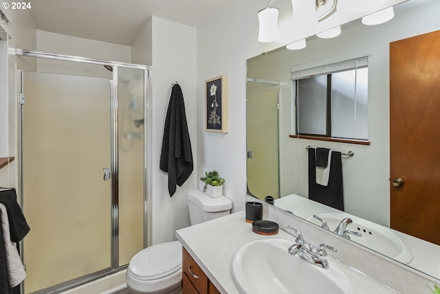 bathroom featuring vanity, toilet, and an enclosed shower