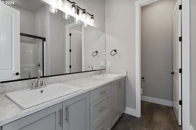 bathroom featuring toilet, vanity, and hardwood / wood-style flooring