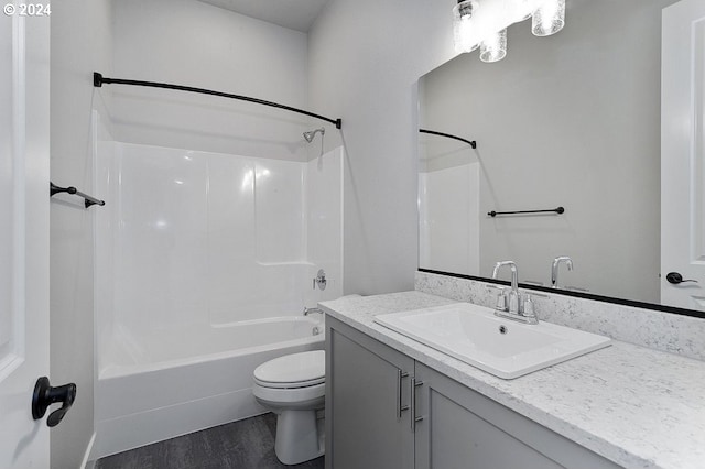 full bathroom featuring hardwood / wood-style floors, vanity, toilet, and shower / washtub combination