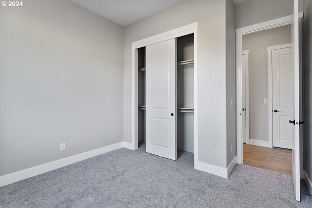 unfurnished bedroom featuring a closet and carpet