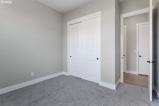 unfurnished bedroom featuring carpet flooring and a closet