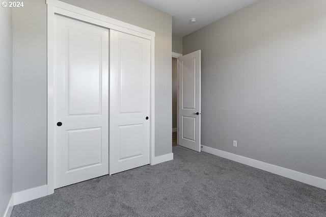 unfurnished bedroom with carpet and a closet