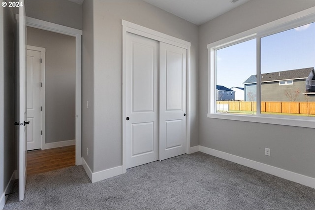 unfurnished bedroom with carpet floors and a closet