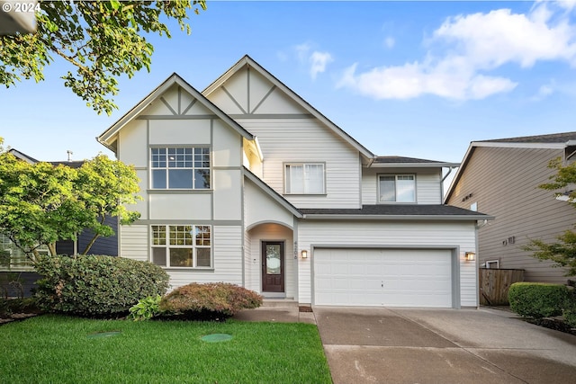 view of front of property featuring a front yard and a garage